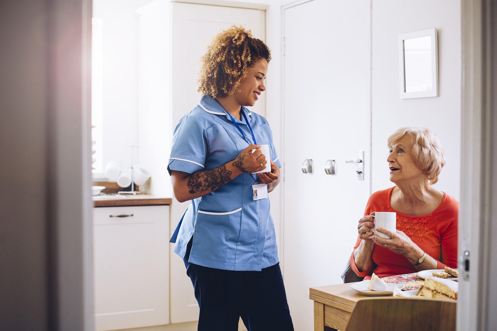Surge Learning Home care Nurse having coffee with patient